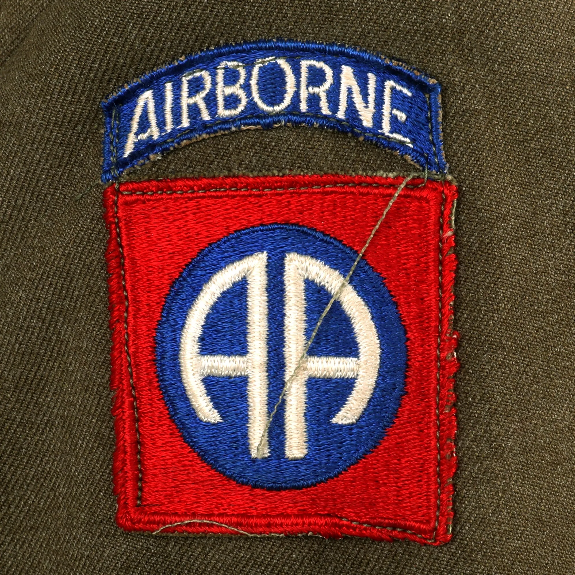 Original U.S. WWII 82nd Airborne Division, 505th Parachute Infantry Regiment Headquarters Ike Jacket Named to Private John M. Cox With Overseas Cap and Plaque